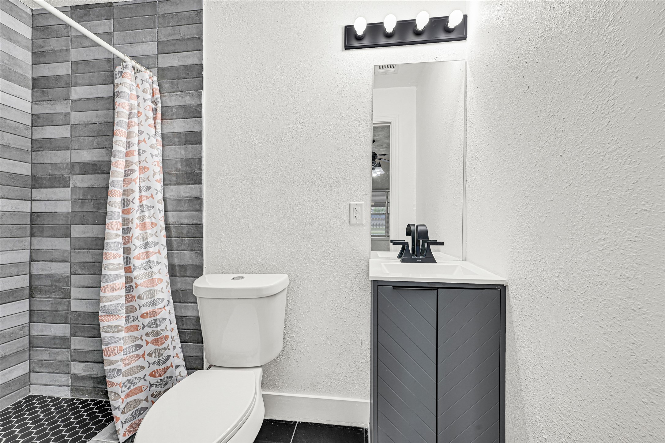 4215 East Lane Houston, TX 77026 - Photo 14 of 25 a bathroom with a toilet a sink and mirror