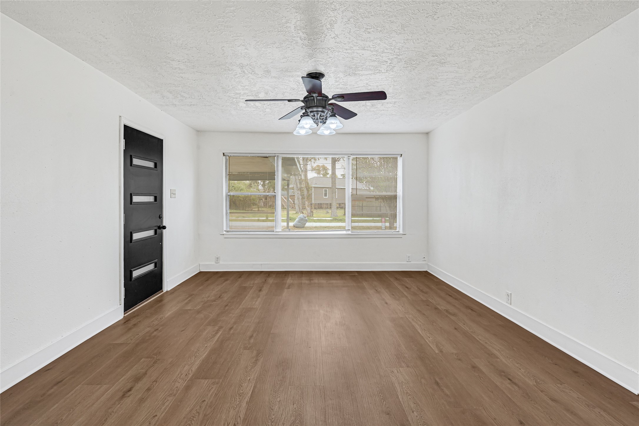 4215 East Lane Houston, TX 77026 - Photo 17 of 25 wooden floor in an empty room with a window