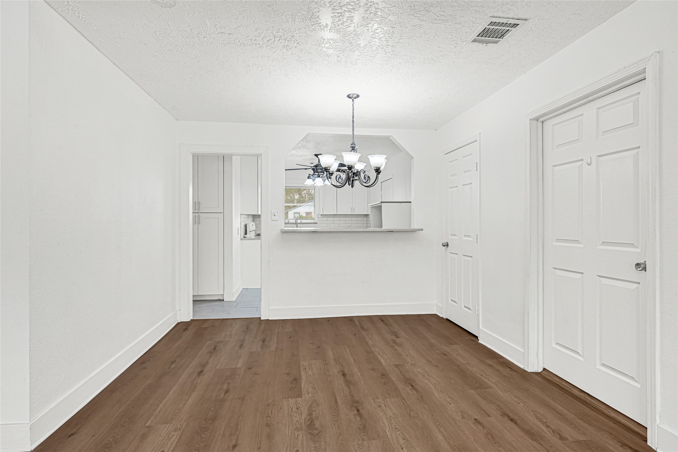 4215 East Lane Houston, TX 77026 - Photo 18 of 25 a view of a room with wooden floor and chandelier