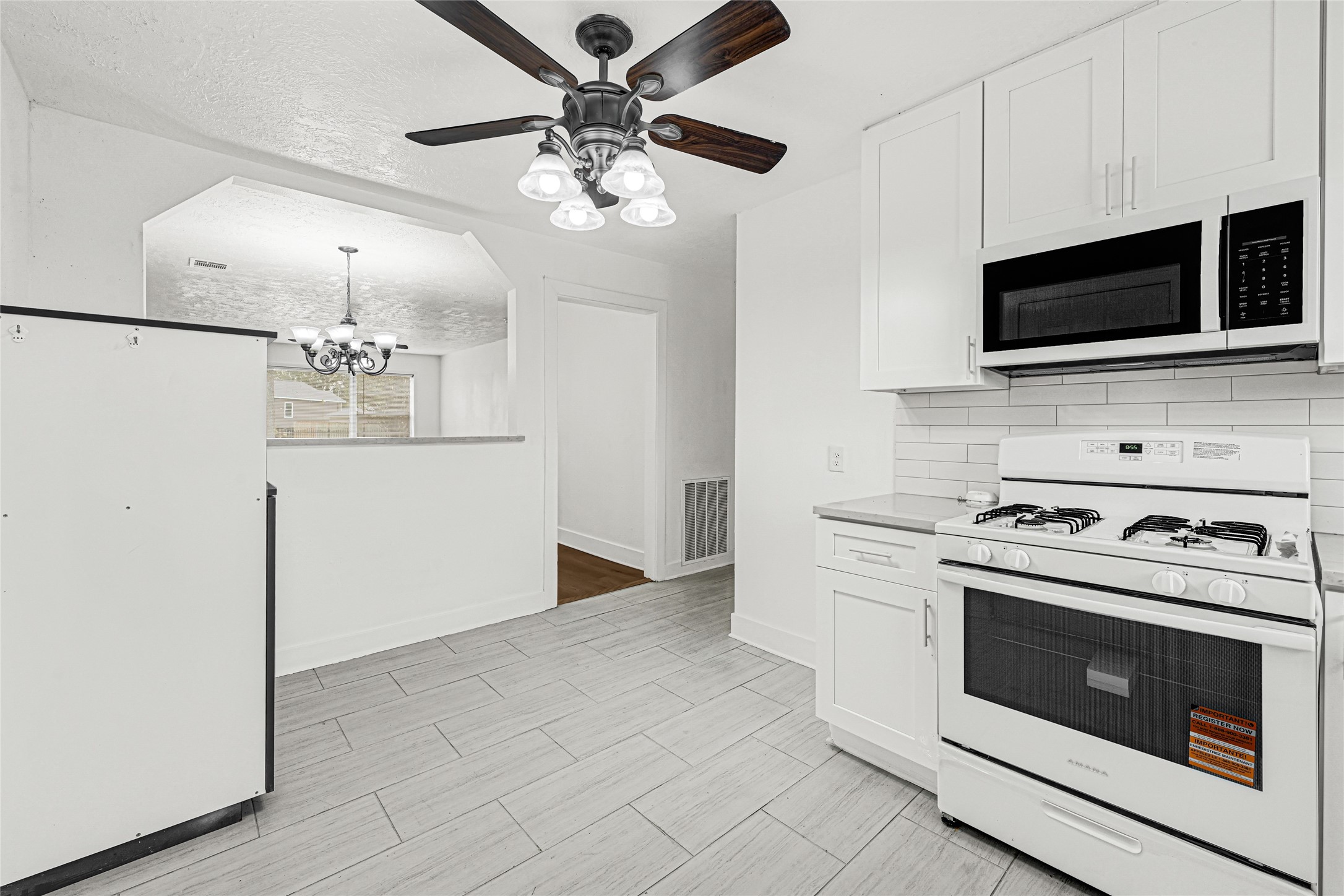 4215 East Lane Houston, TX 77026 - Photo 21 of 25 a kitchen with stainless steel appliances a stove microwave and cabinets