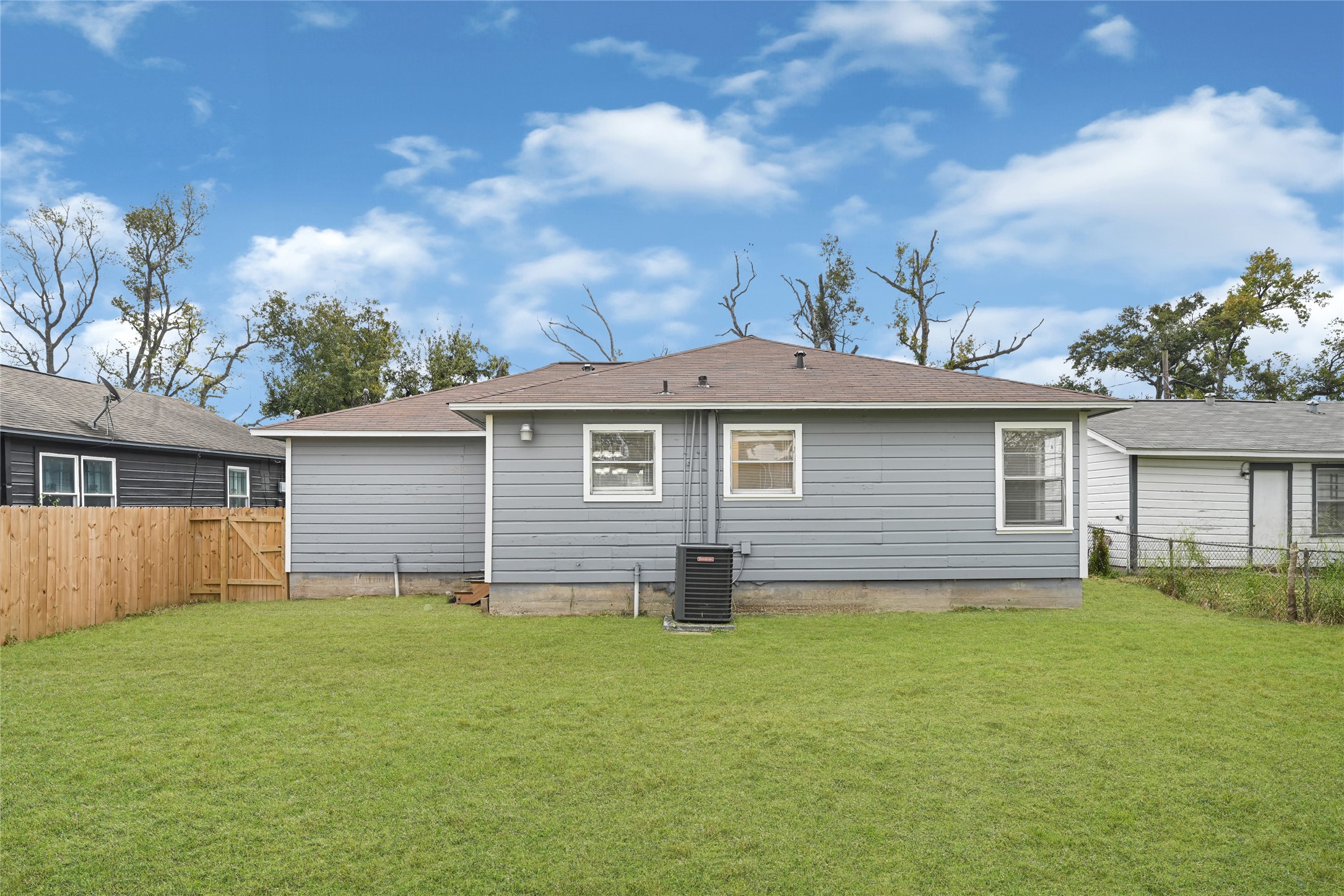 4215 East Lane Houston, TX 77026 - Photo 23 of 25 a front view of house with yard and trees in the background