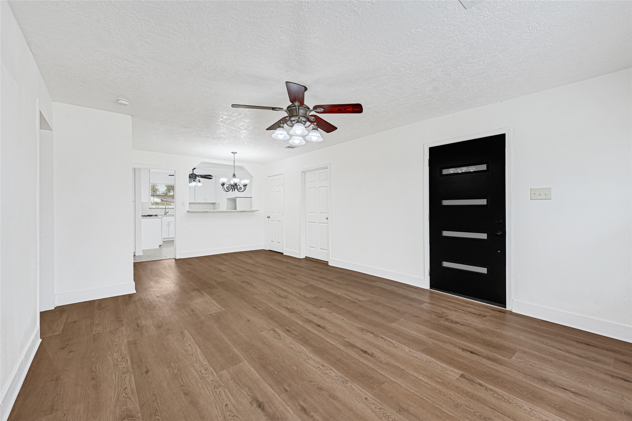 4215 East Lane Houston, TX 77026 - Photo 4 of 25 a view of empty room with wooden floor and ceiling fan