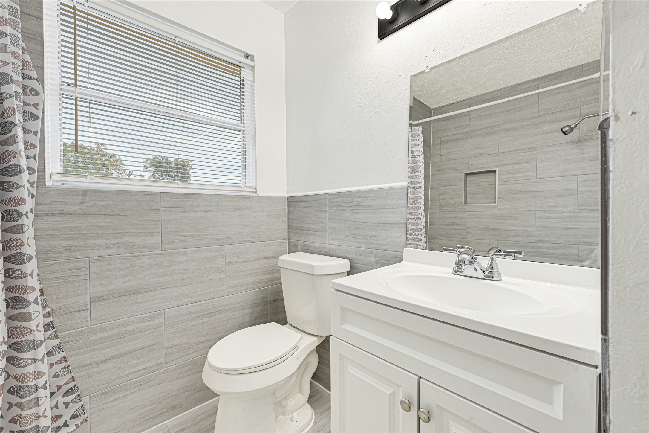 4215 East Lane Houston, TX 77026 - Photo 9 of 25 a bathroom with a sink toilet and a mirror