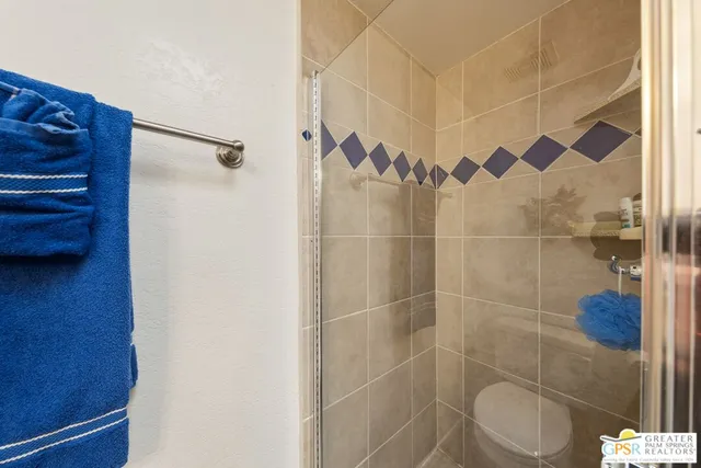 a bathroom with a toilet and a shower