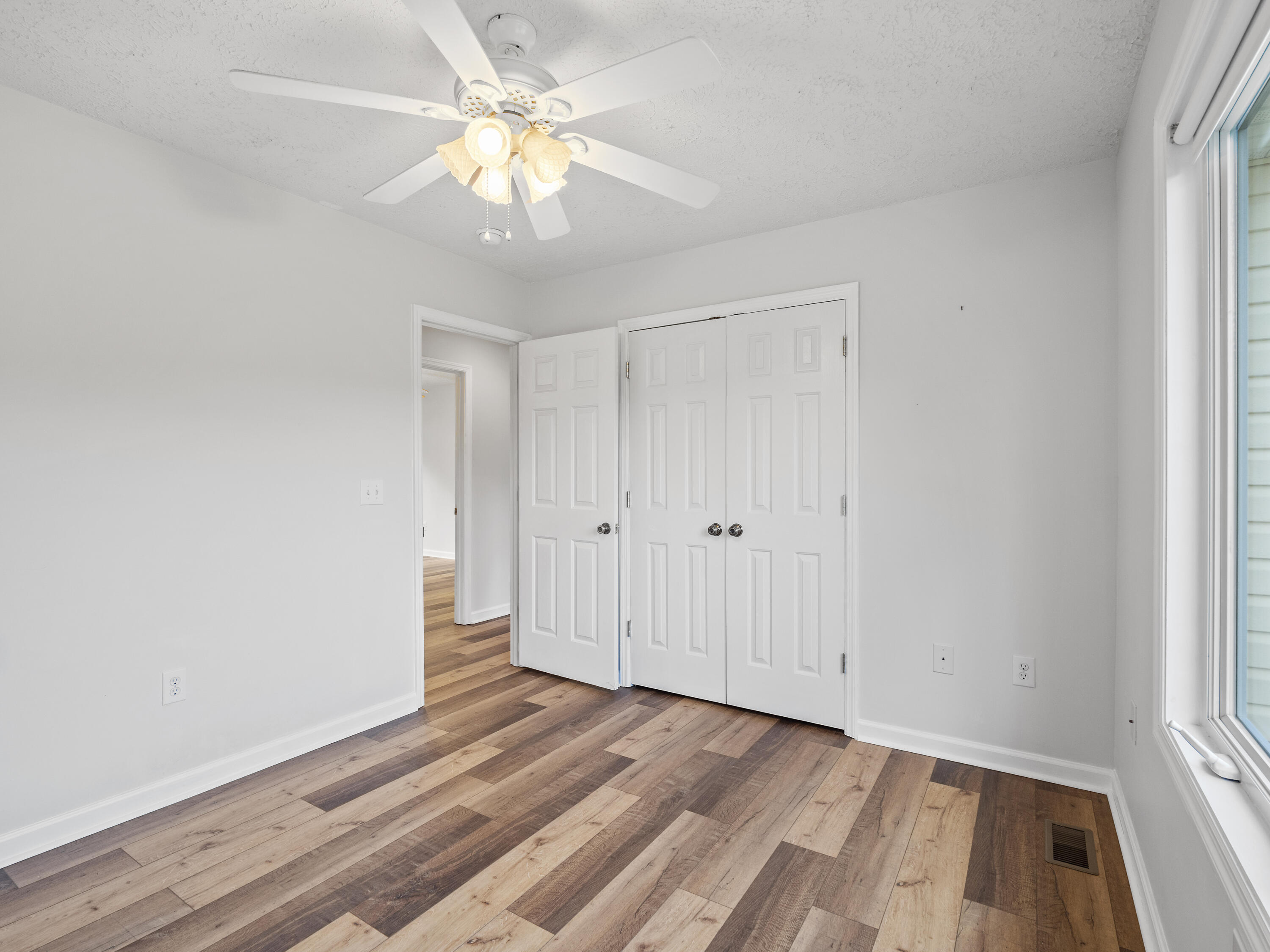 885 Whetstone Road Ferrum, VA 24088 - Photo 30 of 64 a view of a room with wooden floor and a ceiling fan