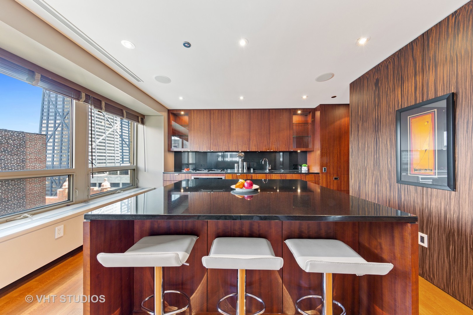 800 North Michigan Avenue, Unit 2003 Chicago, IL 60611 - Photo 11 of 23 a kitchen with a table chairs stove and kitchen island