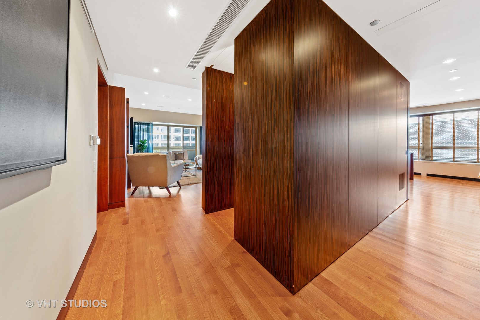 800 North Michigan Avenue, Unit 2003 Chicago, IL 60611 - Photo 4 of 23 a view of a hallway with chairs and wooden floor