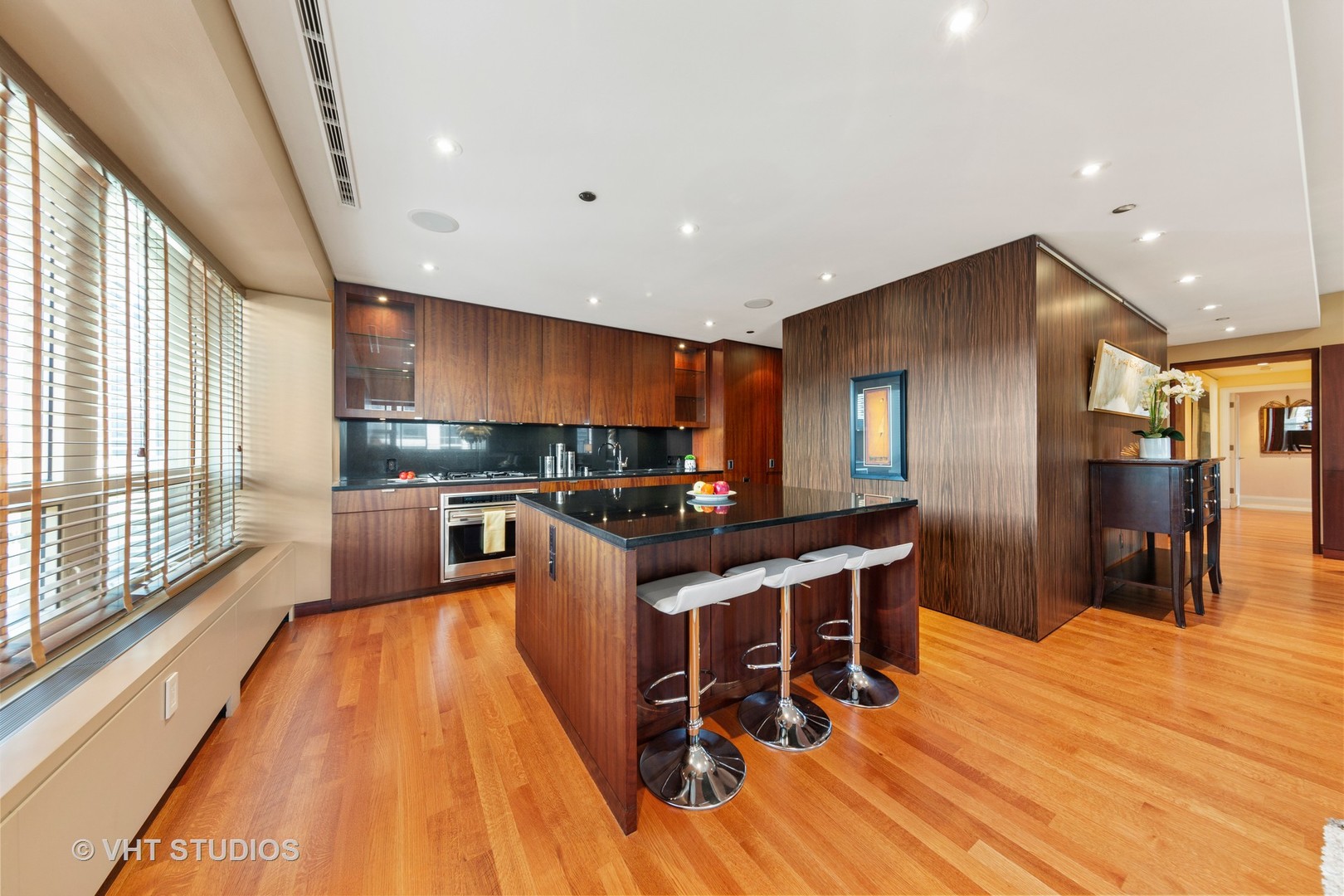 800 North Michigan Avenue, Unit 2003 Chicago, IL 60611 - Photo 10 of 23 a kitchen with stainless steel appliances granite countertop a refrigerator a stove top oven a sink dishwasher and couches with wooden floor