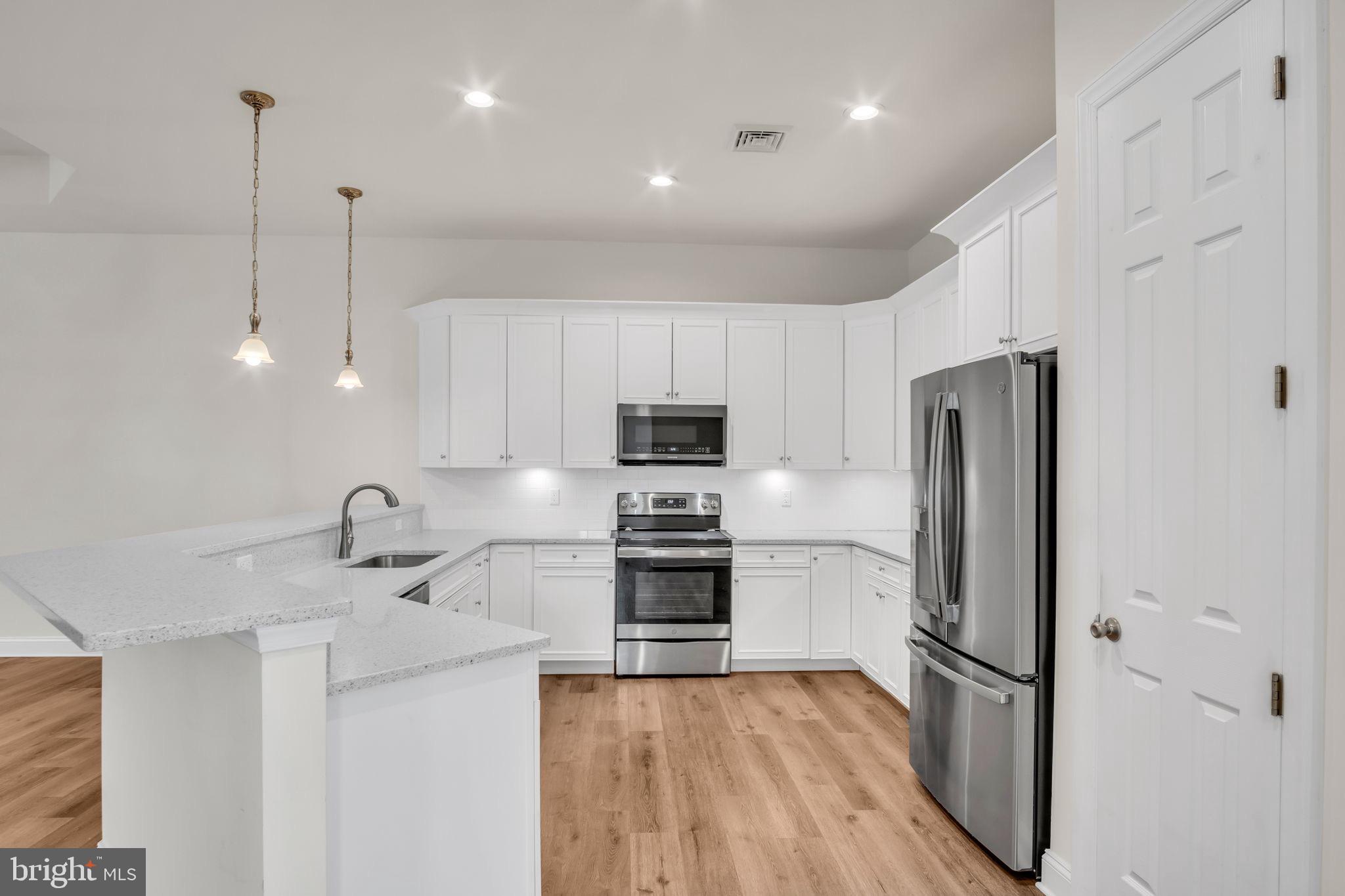 2224 Eastern Boulevard, Unit B York, PA 17402 - Photo 11 of 60 a kitchen with kitchen island a counter top space stainless steel appliances and cabinets
