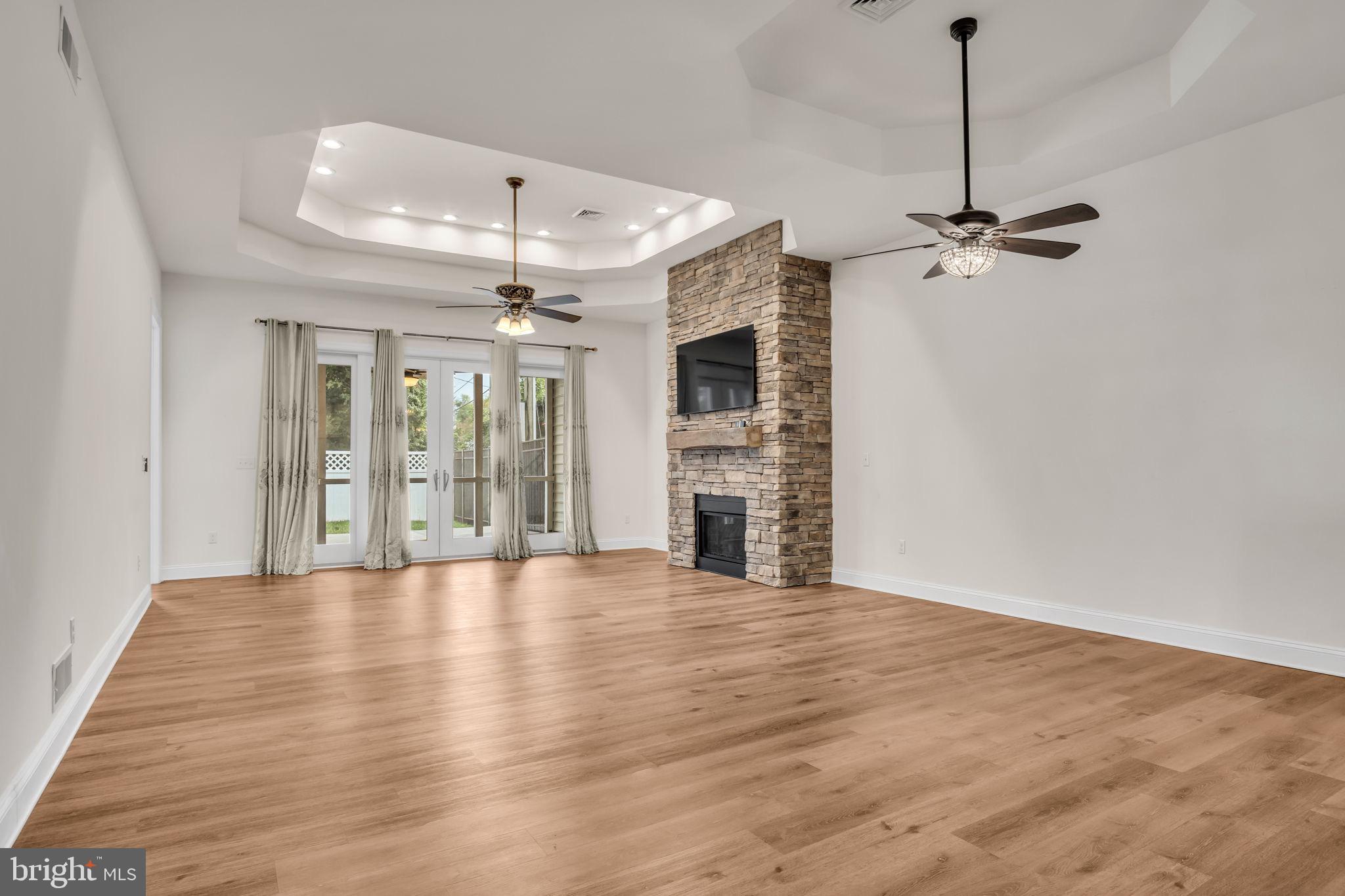 2224 Eastern Boulevard, Unit B York, PA 17402 - Photo 15 of 60 an empty room with wooden floor ceiling fan and windows