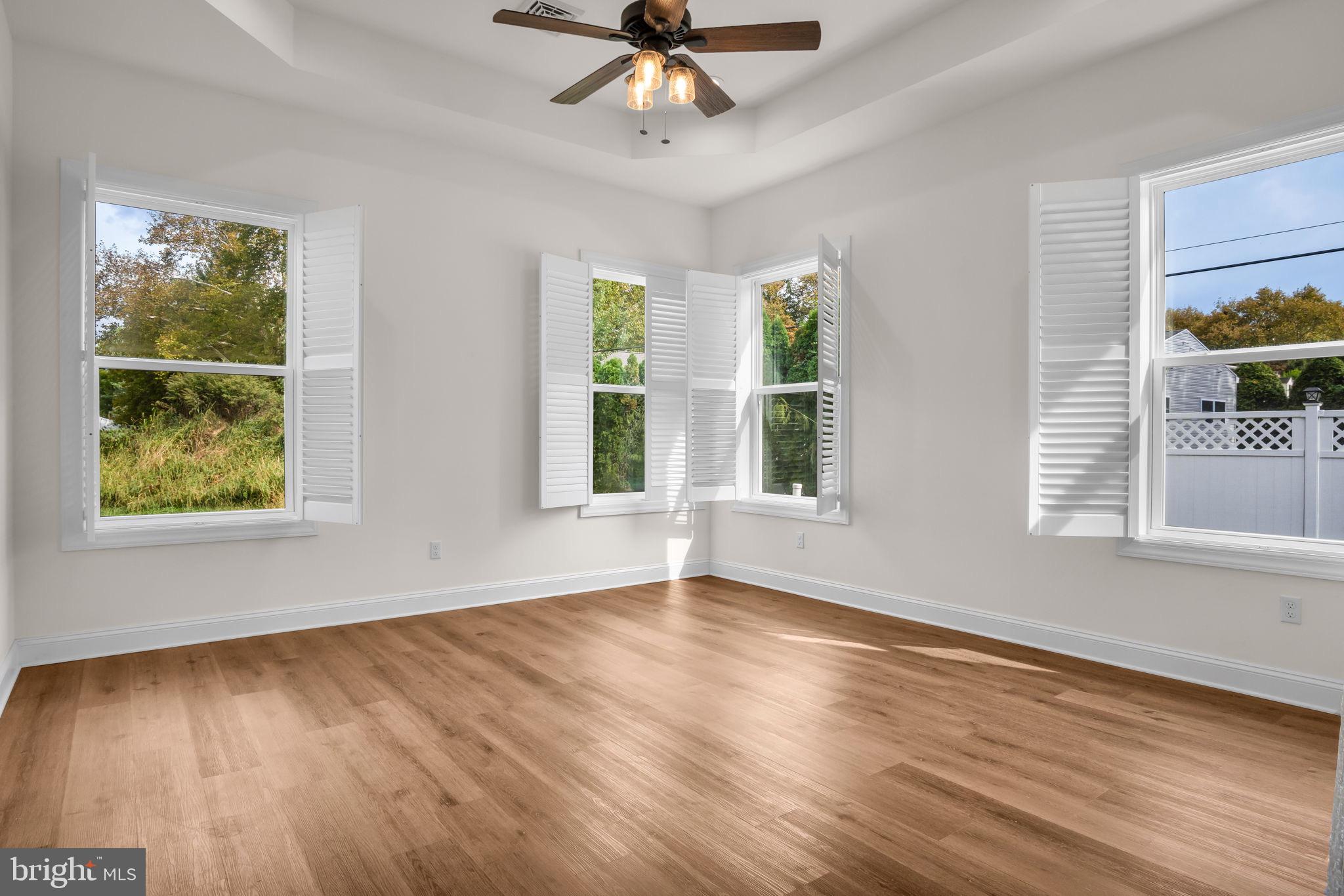 2224 Eastern Boulevard, Unit B York, PA 17402 - Photo 19 of 60 a view of an empty room with wooden floor and a window