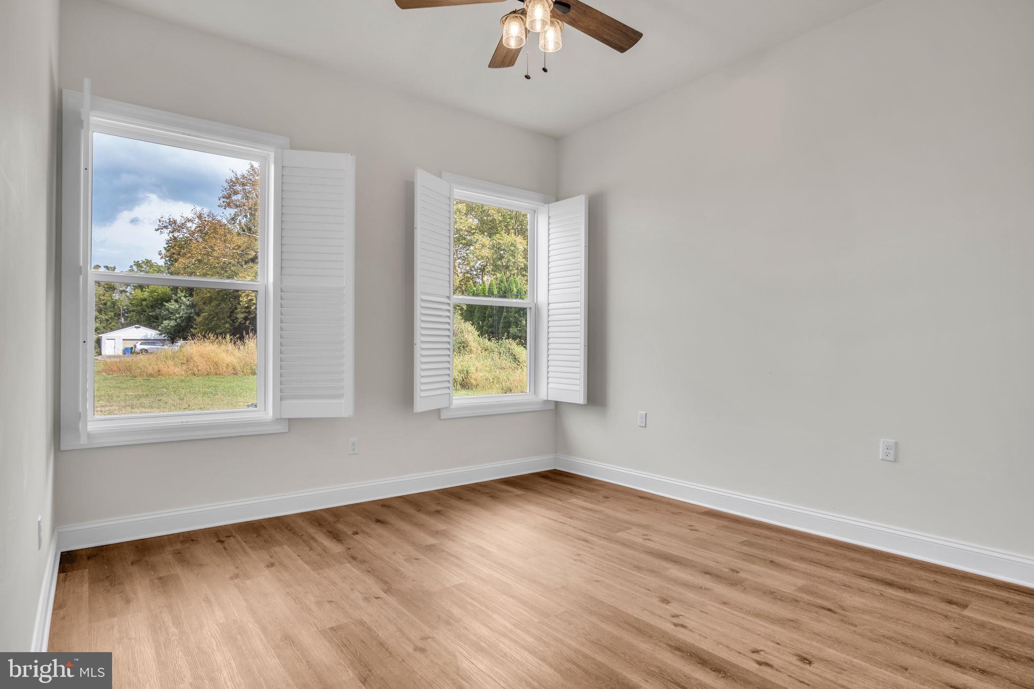 2224 Eastern Boulevard, Unit B York, PA 17402 - Photo 25 of 60 a view of an empty room with wooden floor and a window