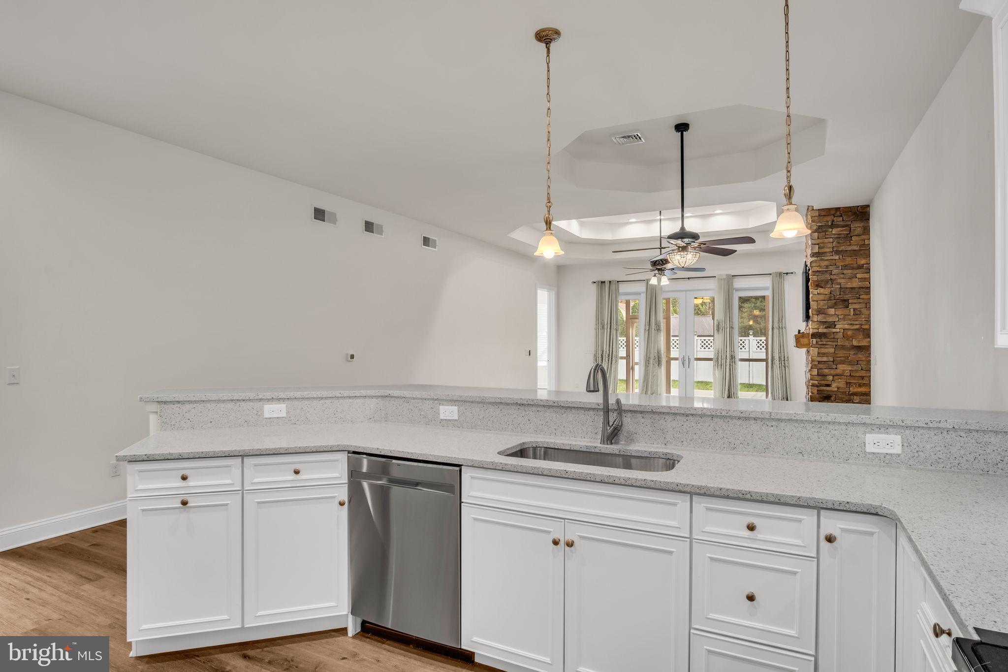 2224 Eastern Boulevard, Unit B York, PA 17402 - Photo 10 of 60 a kitchen with a sink dishwasher and white cabinets with wooden floor