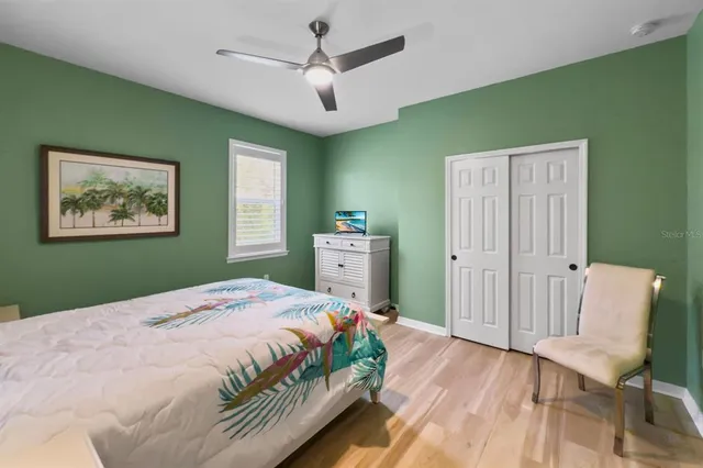 a bedroom with a bed and a chair