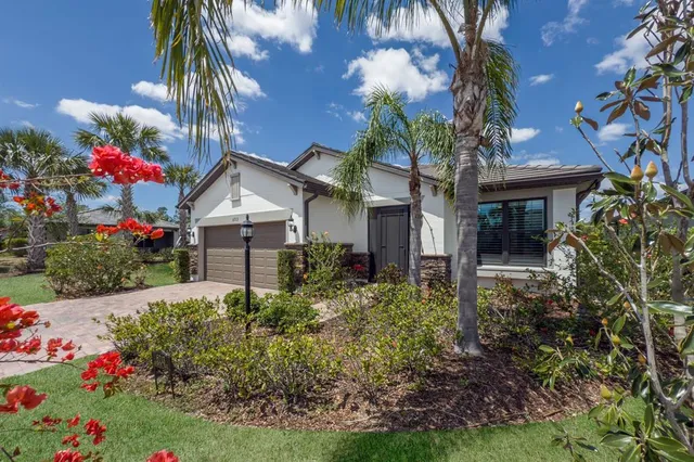 a front view of a house with a flower garden