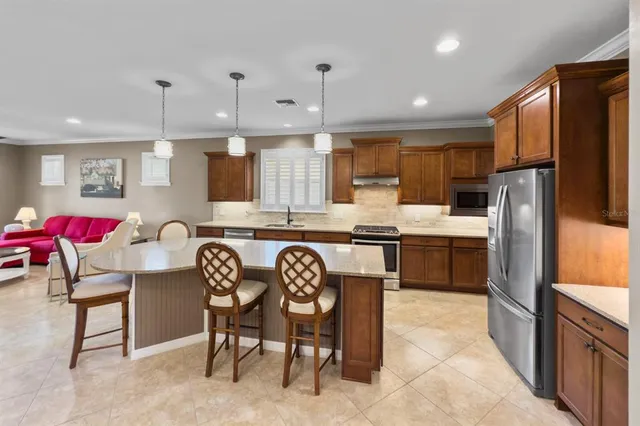 a large kitchen with a table and chairs