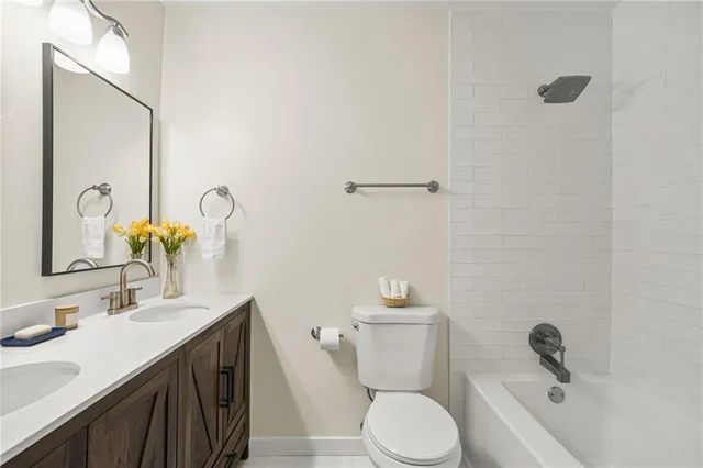a bathroom with a sink vanity granite and toilet