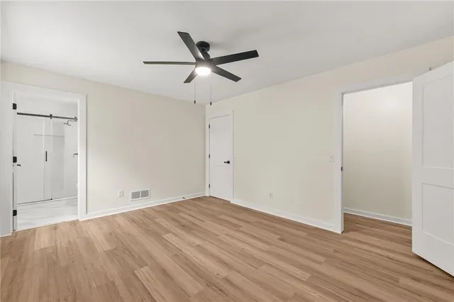 a view of empty room with wooden floor