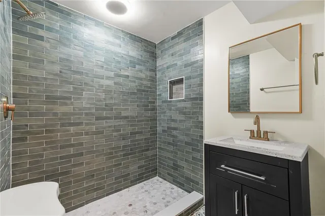 a bathroom with a sink a toilet and mirror