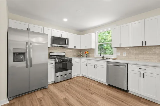 a kitchen with a refrigerator stove and microwave
