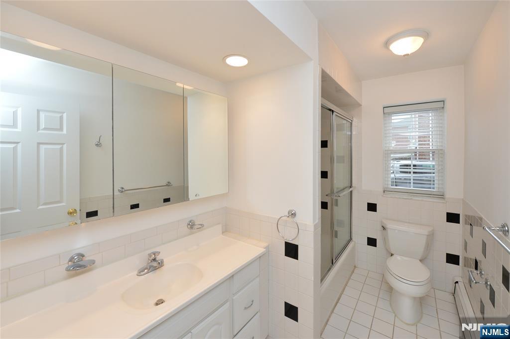 21-31 Ridge Road, Unit D15 Ridgewood, NJ 07450 - Photo 7 of 16 a bathroom with a sink a toilet and shower