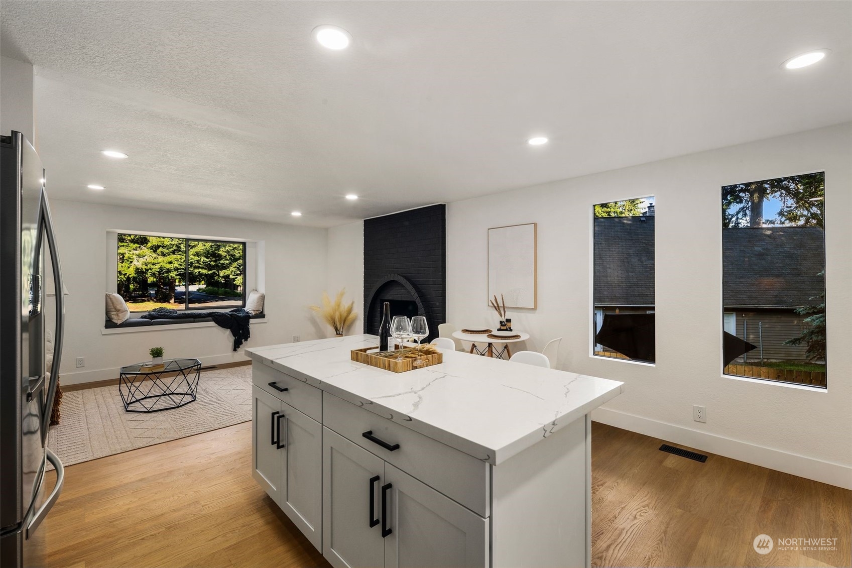 3006 164th Place Southeast Bothell, WA 98012 - Photo 14 of 39 a view of kitchen island a sink wooden floor and living room view