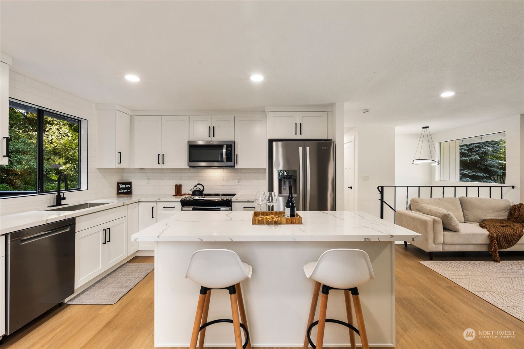 3006 164th Place Southeast Bothell, WA 98012 - Photo 15 of 39 a kitchen with stainless steel appliances granite countertop a stove top oven a refrigerator a sink and chairs