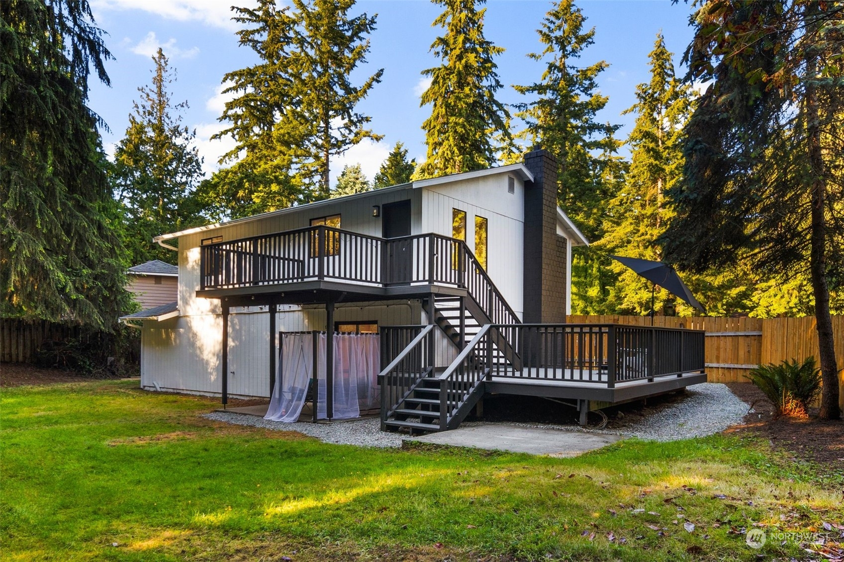 3006 164th Place Southeast Bothell, WA 98012 - Photo 27 of 39 a view of a house with a yard deck and a small yard