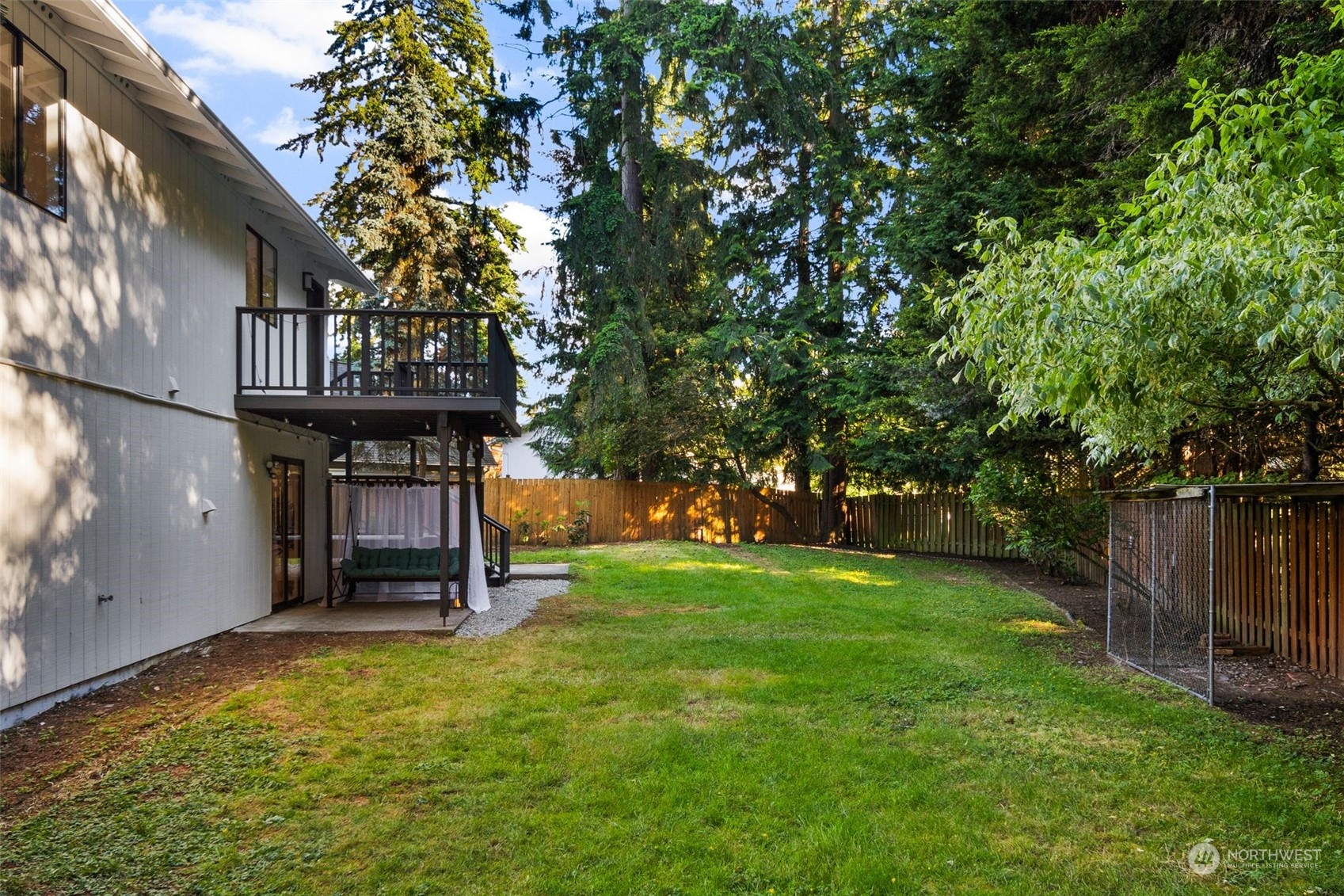 3006 164th Place Southeast Bothell, WA 98012 - Photo 32 of 39 a backyard of a house with barbeque oven table and chairs