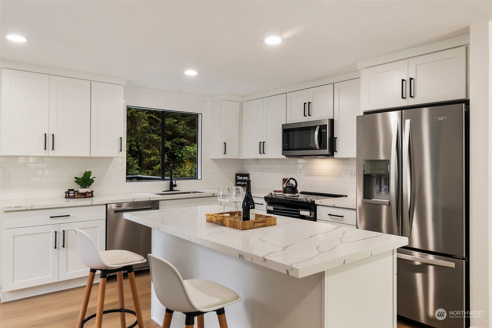 3006 164th Place Southeast Bothell, WA 98012 - Photo 10 of 39 a kitchen with a refrigerator a stove a sink a dining table and chairs