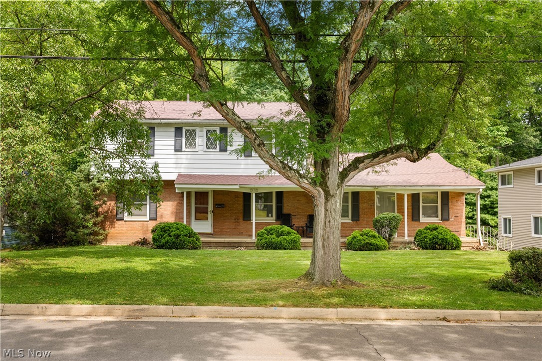 542 Garnette Road Akron, OH 44313 - Photo 2 of 24 Traditional two-story residence featuring a brick facade, white siding, and dark shutters