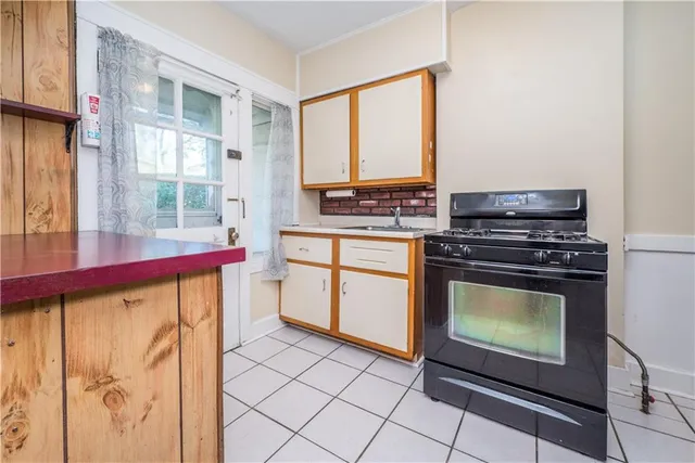 a kitchen with stainless steel appliances a stove a sink and a microwave