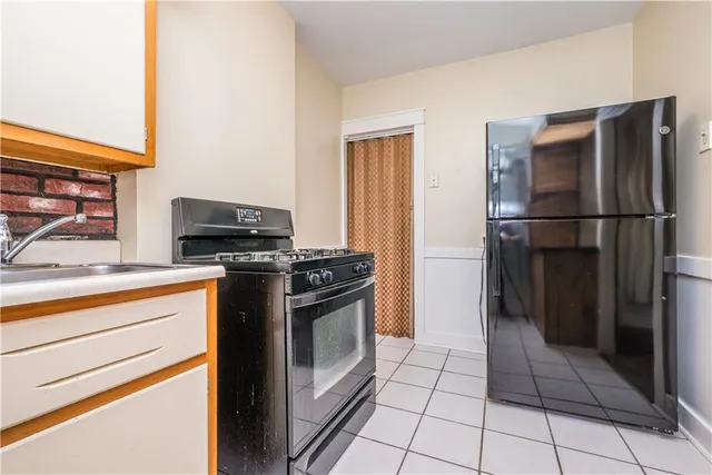 a kitchen with a stove top oven and refrigerator
