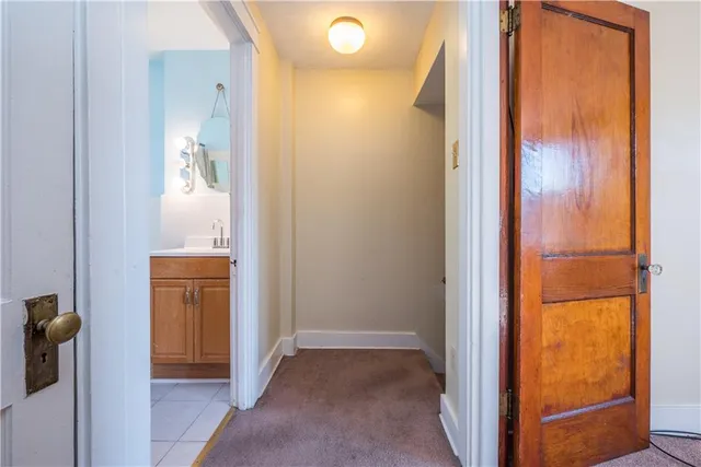 view of hallway with bathroom