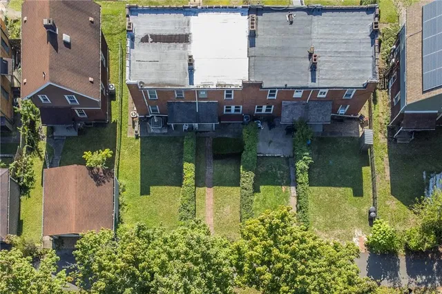 aerial view of a house with a yard and a fountain