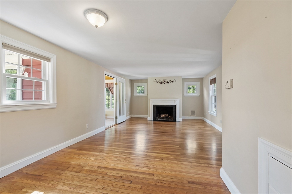 1 Beech Circle Andover, MA 01810 - Photo 11 of 40 a view of empty room with fireplace and wooden floor