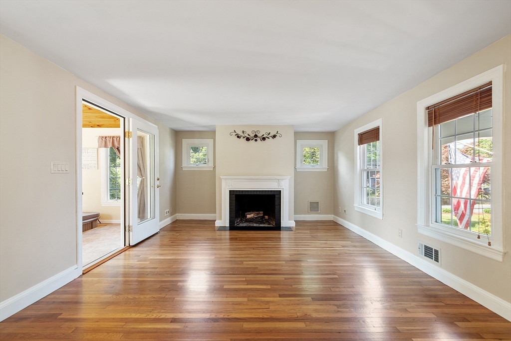 1 Beech Circle Andover, MA 01810 - Photo 13 of 40 an empty room with windows a fireplace and wooden floor