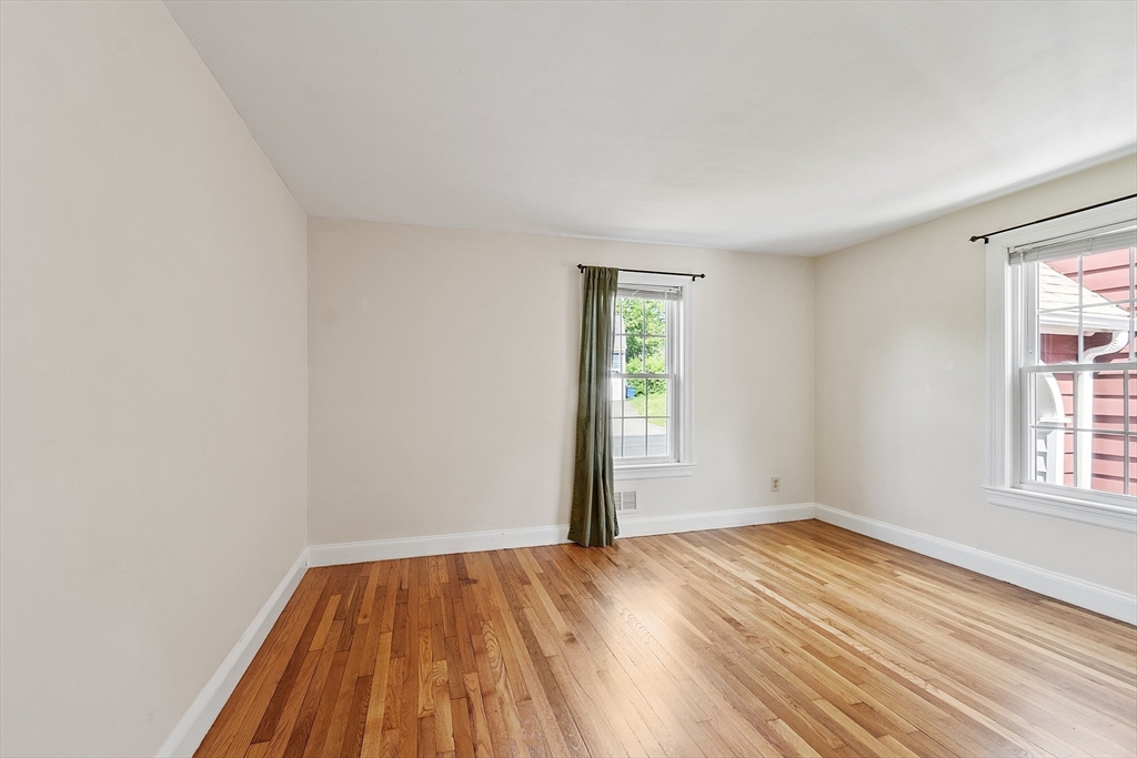 1 Beech Circle Andover, MA 01810 - Photo 18 of 40 an empty room with wooden floor and windows