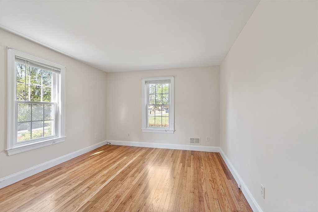 1 Beech Circle Andover, MA 01810 - Photo 19 of 40 an empty room with wooden floor and windows
