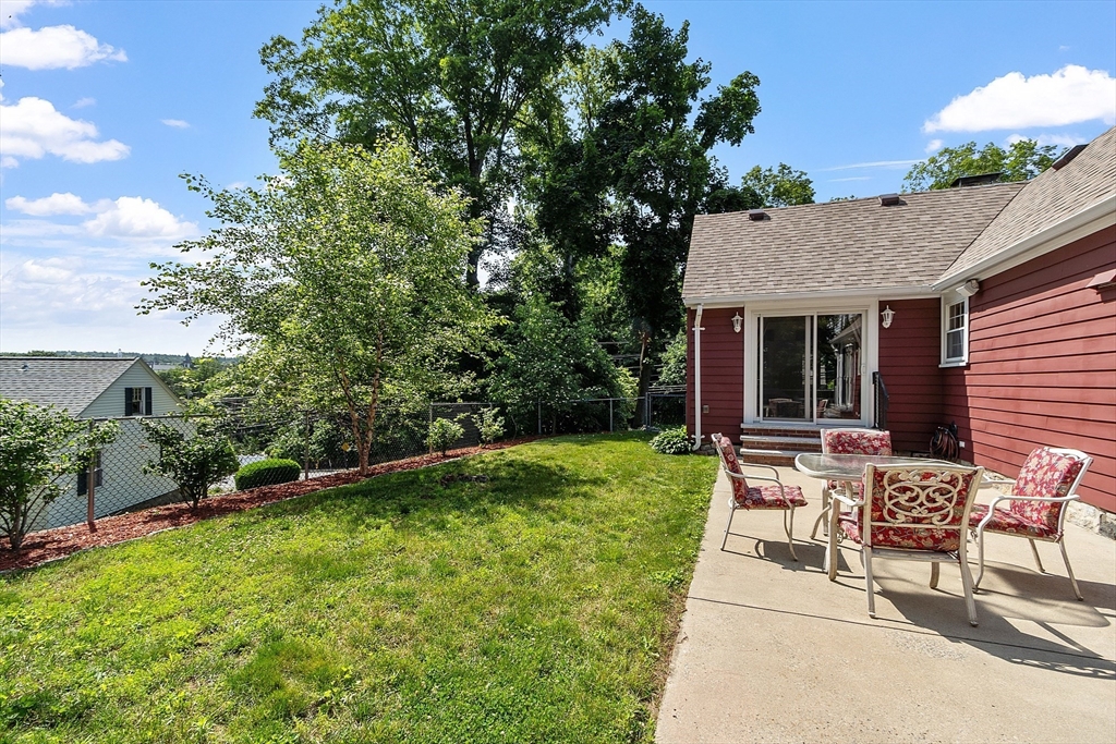 1 Beech Circle Andover, MA 01810 - Photo 30 of 40 a view of a house with backyard sitting area and garden