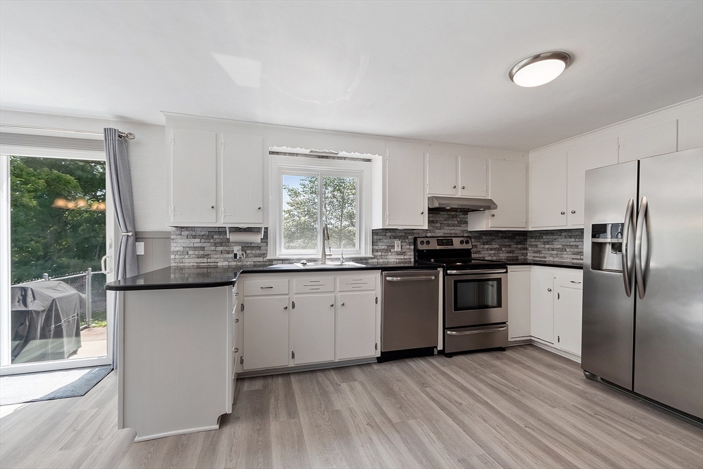 1 Beech Circle Andover, MA 01810 - Photo 3 of 40 a kitchen with granite countertop a refrigerator stove top oven and sink