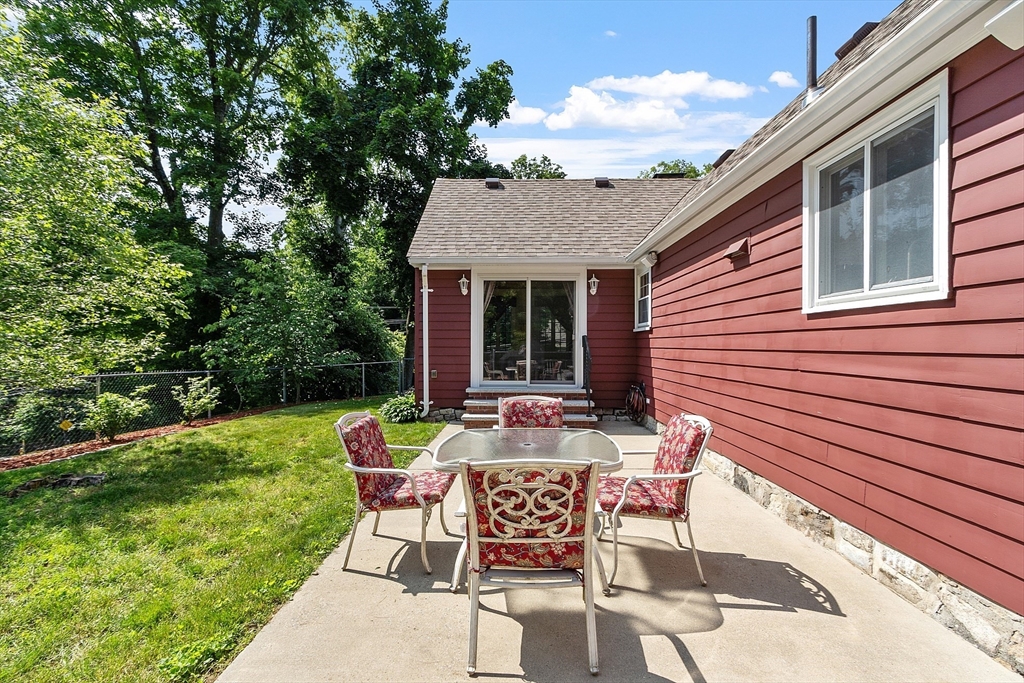 1 Beech Circle Andover, MA 01810 - Photo 31 of 40 a patio with table and chairs and potted plants