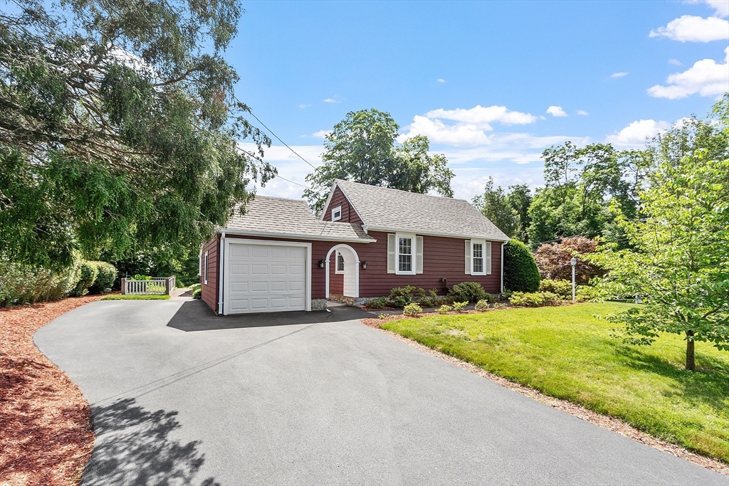 1 Beech Circle Andover, MA 01810 - Photo 39 of 40 a front view of a house with a yard and garage