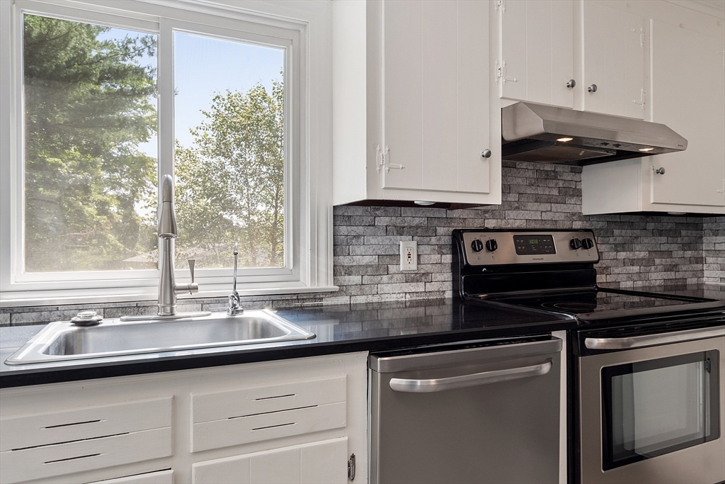 1 Beech Circle Andover, MA 01810 - Photo 5 of 40 a kitchen with stainless steel appliances granite countertop a sink and cabinets