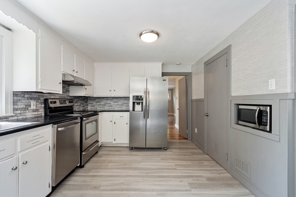 1 Beech Circle Andover, MA 01810 - Photo 6 of 40 a kitchen with stainless steel appliances granite countertop a refrigerator sink and stove