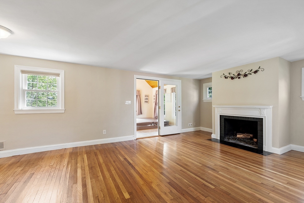 1 Beech Circle Andover, MA 01810 - Photo 10 of 40 an empty room with wooden floor fireplace and windows