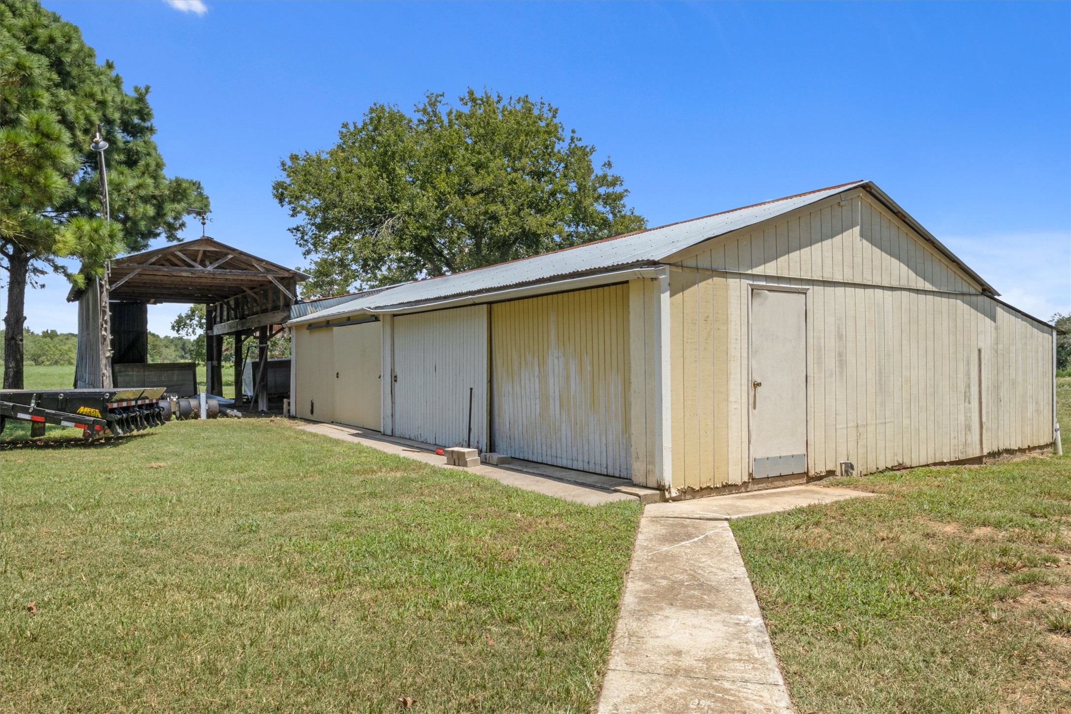 451 Pleasant Grove Road Elgin, TX 78621 - Photo 16 of 26 View of pole building featuring a yard and a carport