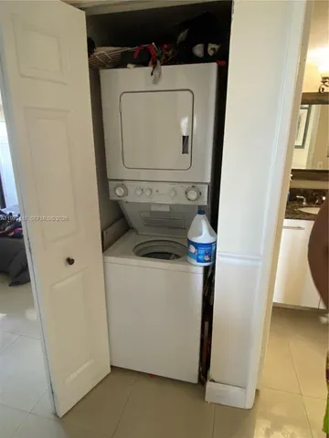 a kitchen with granite countertop a sink a stove and cabinets