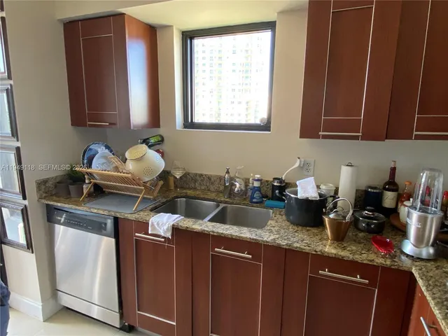 a kitchen with a refrigerator and a sink