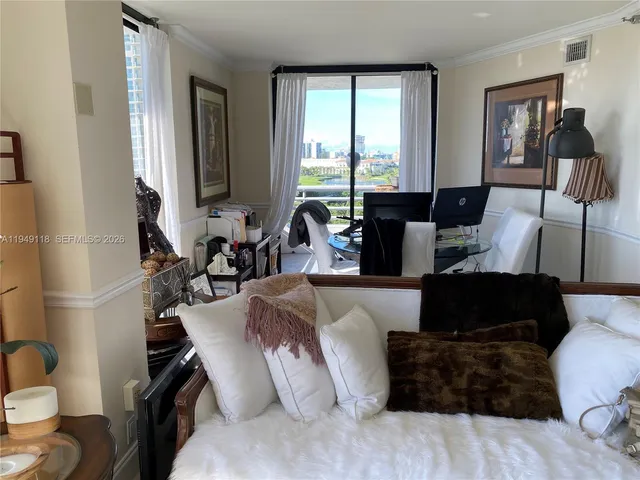 a living room with furniture a window and gym equipment
